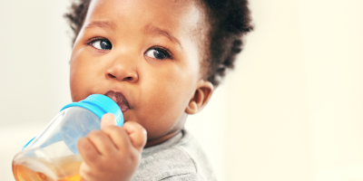 Preschooler sipping from a plastic cup